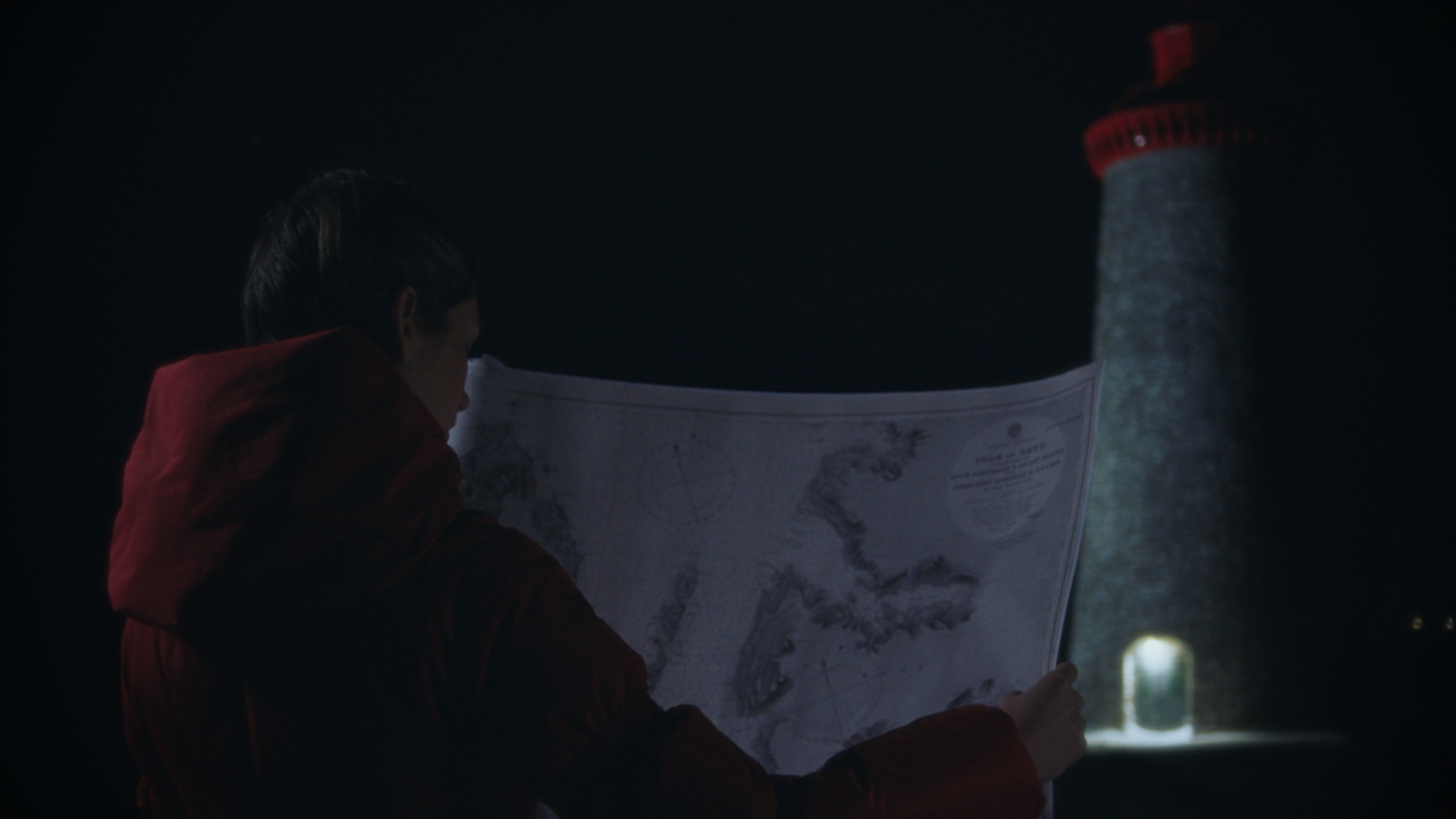 A woman studying an old nautical chart beneath a lighthouse