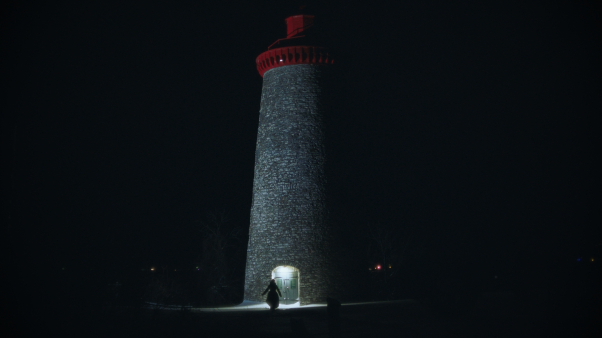 A woman approaching a lighthouse at night from A Solstice Dream