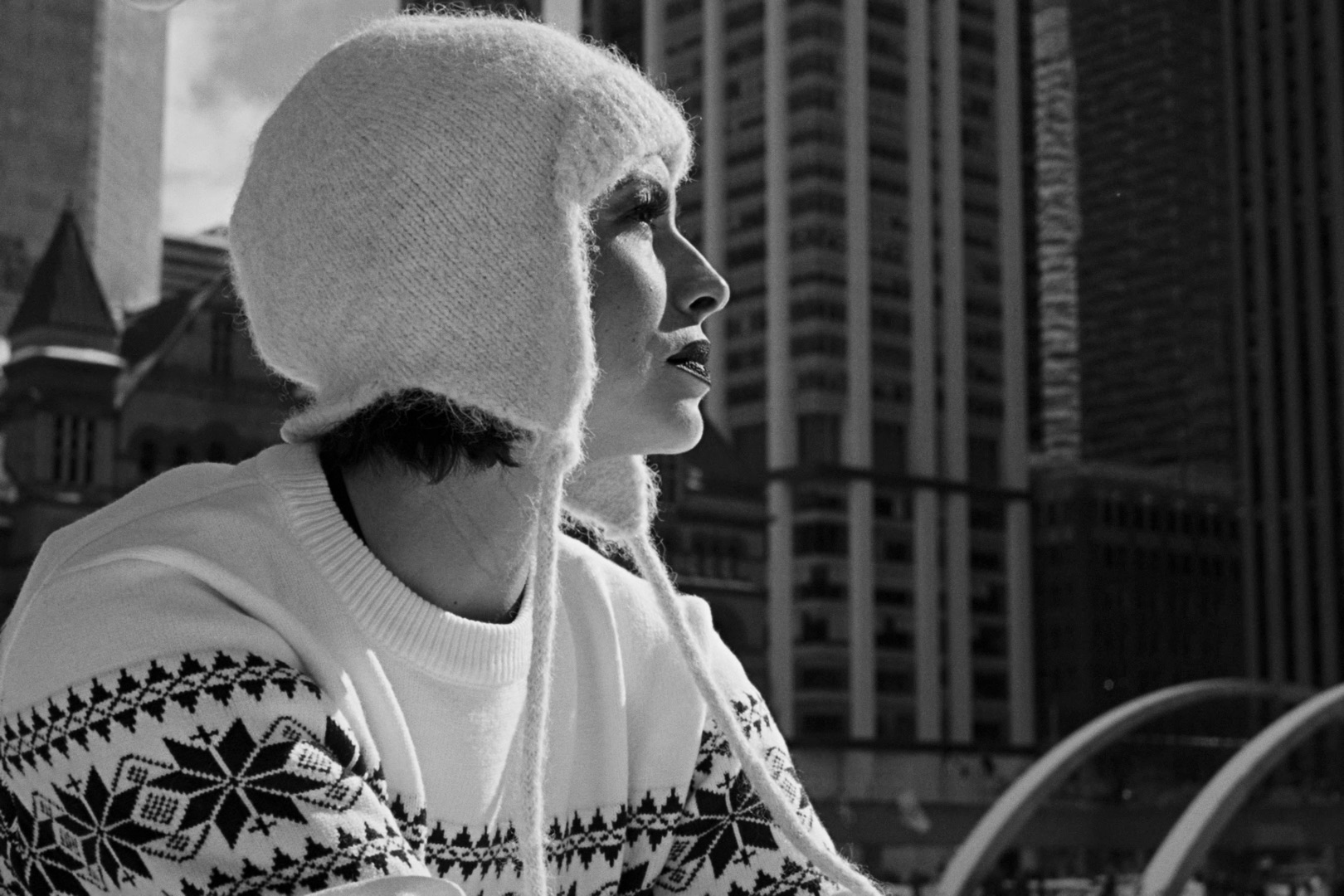 A figure skater in profile against the winter city